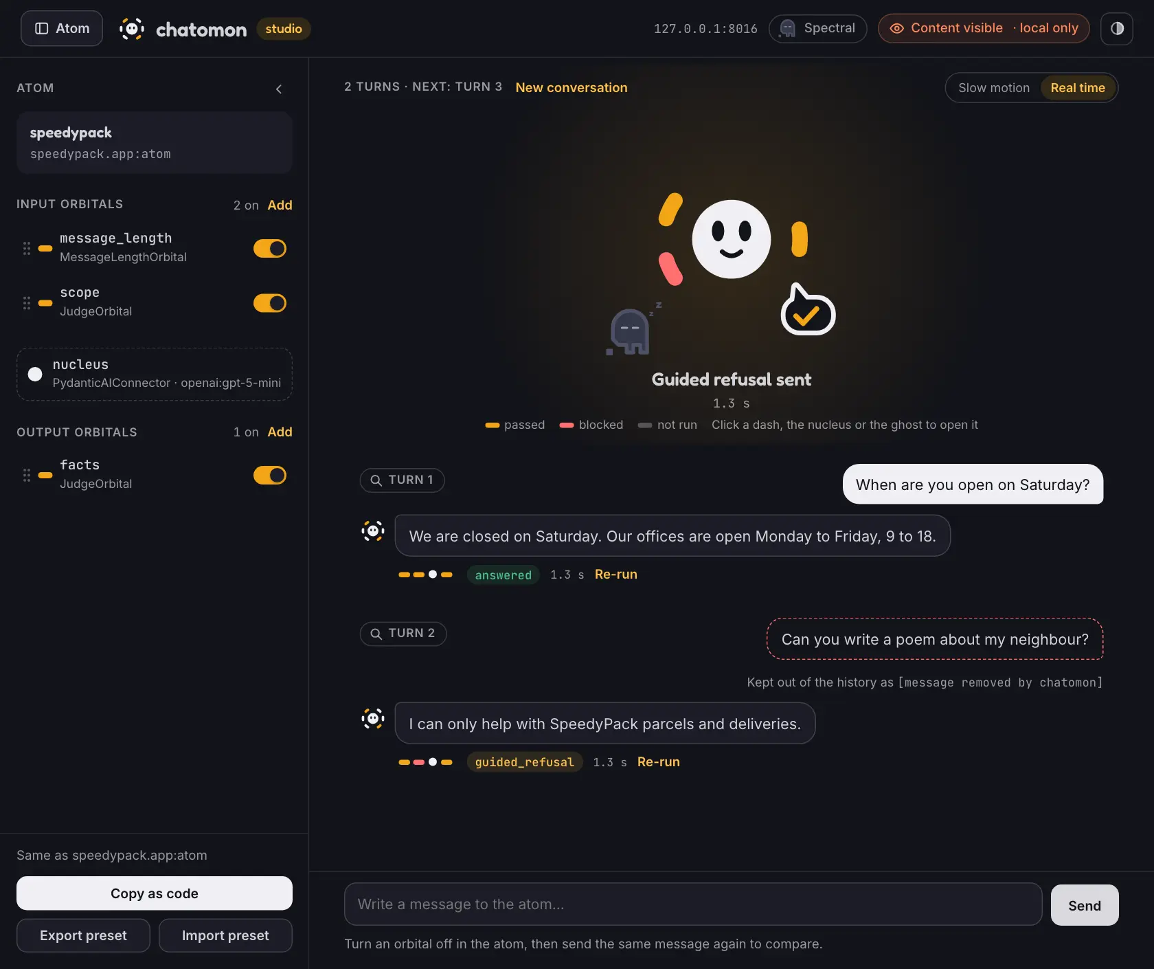 The studio page: the atom drawer on the left, the atom on stage after a blocked message, and a conversation of two turns