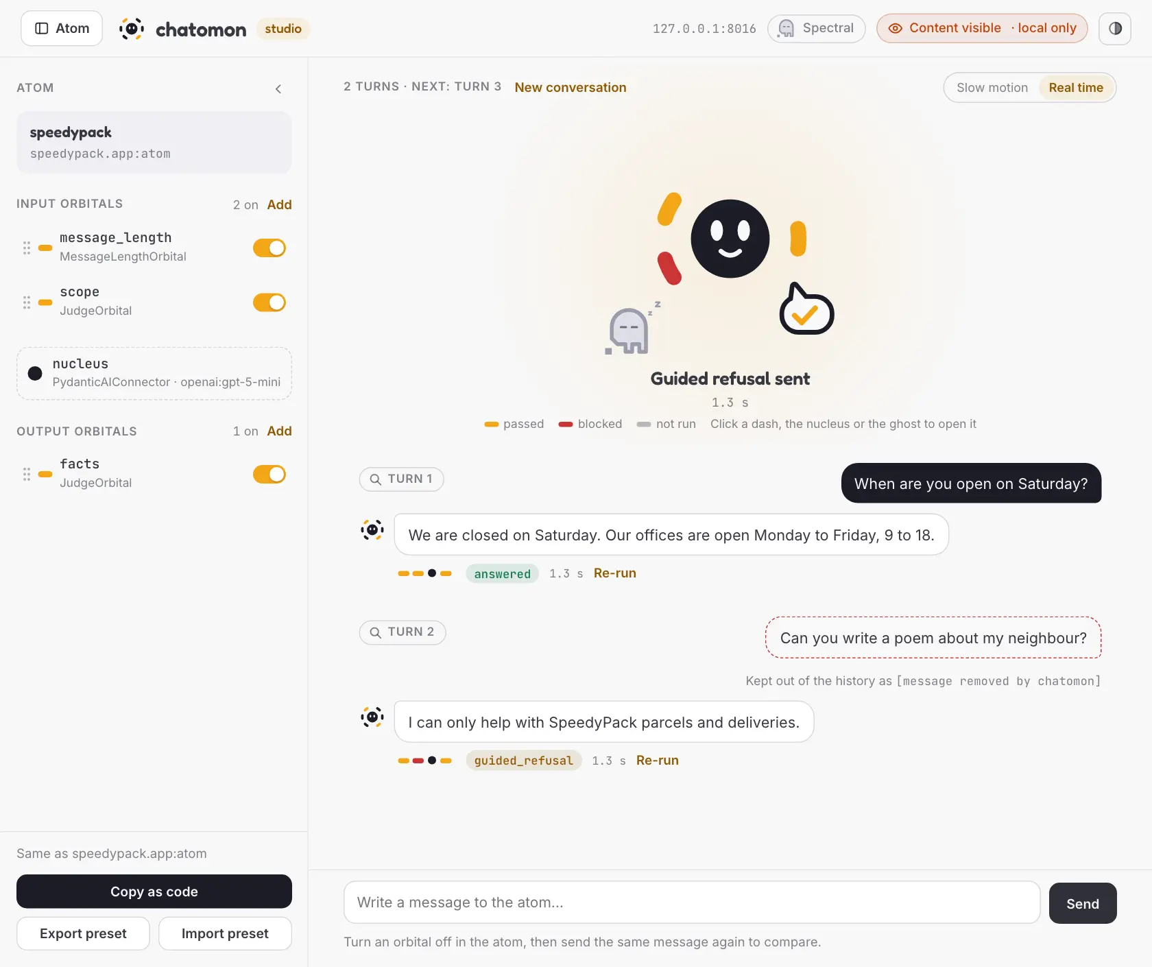 The studio page: the atom drawer on the left, the atom on stage after a blocked message, and a conversation of two turns